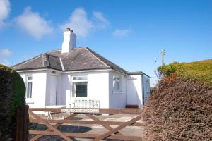 a white house with a lighthouse on top of it at 2 Bed in Berwick-upon-Tweed oc-gd1871 in Ancroft