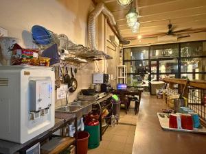 a kitchen with a counter in a restaurant at Dou Houz Georgetown in George Town