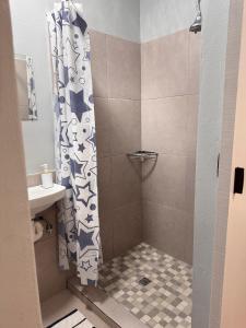 a shower with a shower curtain in a bathroom at HavenTrust Guest house in Goodwood +47 photos