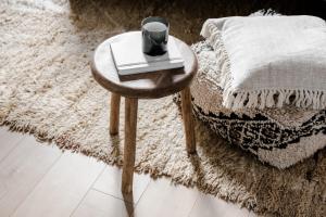 a small wooden table with a cup on top of a rug at Creevy Cove cottage in Kildoney +4 photos