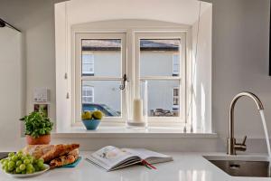 a kitchen counter with a window and a plate of food at 1 Bed in Cilcain oc-s29009 in Cilcain