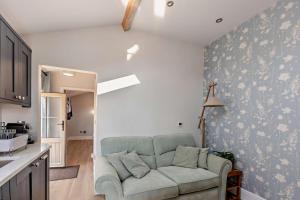 a living room with a couch against a wall at 1 Bed in Cilcain oc-s29009 in Cilcain