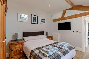 a bedroom with a bed and a tv on the wall at 1 Bed in Cilcain oc-s29009 in Cilcain +19 photos