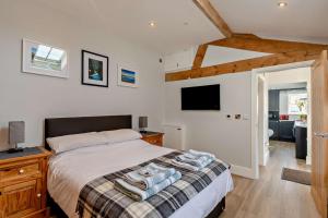 a bedroom with a bed and a flat screen tv at 1 Bed in Cilcain oc-s29009 in Cilcain