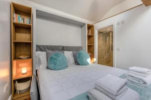 a bedroom with a bed with blue pillows at 1 Bed in Cerrigydrudion oc-bow194 in Cerrig-y-Druidion
