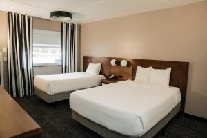 a hotel room with two beds and a window at Dutch Wonderland Inn in Lancaster +46 photos