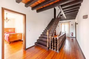 a bedroom with a staircase and a bed in a room at "Venetian Elegance Villa" - near Venice historic center in Mira