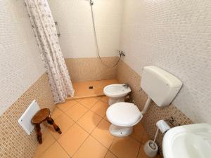 a small bathroom with a toilet and a sink at Villa Flora Gallipoli in Il Monte +50 photos