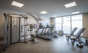 a gym with several treadmills and cardio machines at Maldron Hotel Glasgow City in Glasgow
