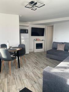 a living room with a couch and a table at ARY Montan in Petroşani