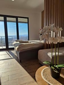 a bedroom with two beds and a table with flowers at Wine House Churilo in Ohrid