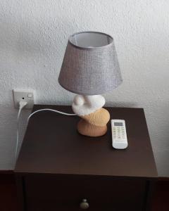 a lamp on a table next to a remote control at E-Beach Resort in Negombo