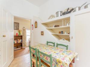 a dining room with a table and chairs at The Cottage in Slickly +9 photos