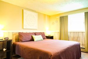 a bedroom with a large bed with a orange blanket at Fall Getaway in Bessemer