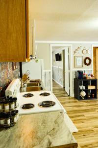 a kitchen with a stove and a sink in it at Fall Getaway in Bessemer