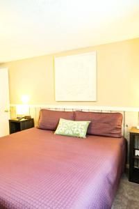 a bedroom with a bed with a purple blanket at Fall Getaway in Bessemer +21 photos