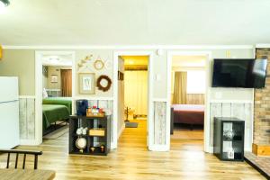 a living room with a television and a fireplace at Fall Getaway in Bessemer