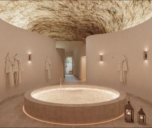 a large bath tub in a room with a ceiling at Relais d'Amboise - The Leading Hotels of the World in Amboise +24 photos