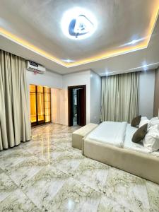 a bedroom with a large bed with a marble floor at One bedroom apartment Presidential suite in Abuja