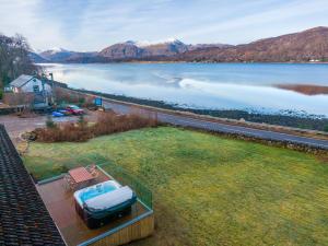 a house with a view of a body of water at Glenachulish Bay with Hot Tub in Glencoe