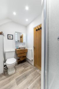 a bathroom with a toilet and a sink at Stone Barn in Minehead