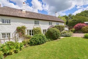 a white house with a garden in front of it at 3 Bed in Dalwood oc-p27362 in Dalwood