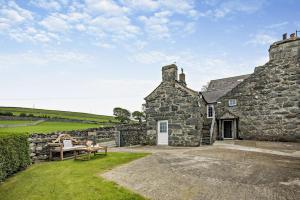 an old stone house with a picnic table in front of it at 1 Bed in Dyffryn Ardudwy oc-g29349 in Dyffryn
