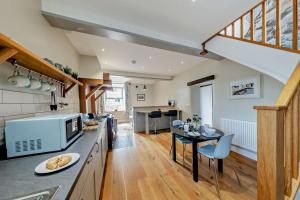 a kitchen with a table and a dining room at 1 Bed in Dyffryn Ardudwy oc-g29349 in Dyffryn