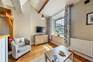 a living room with a chair and a table at 1 Bed in Dyffryn Ardudwy oc-g29349 in Dyffryn