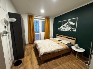 a bedroom with a bed and a table in it at Štúdio Sihoť - parkovanie a nabíjanie EV in Trenčín