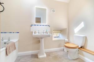 a bathroom with a sink and a toilet and a mirror at 2 Bed in Oxborough oc-t29292 in Oxborough +16 photos
