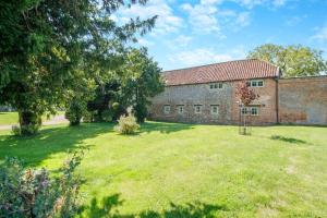 an old brick building with a large yard at 2 Bed in Oxborough oc-t29292 in Oxborough