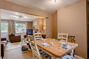 a kitchen and living room with a wooden table and chairs at 2 Bed in Dersingham oc-p28040 in Dersingham
