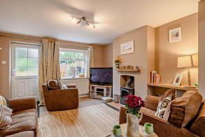 a living room with a couch and a tv at 2 Bed in Dersingham oc-p28040 in Dersingham