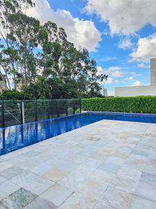 a swimming pool on the roof of a house at Emilie Home in Sao Jose do Rio Preto