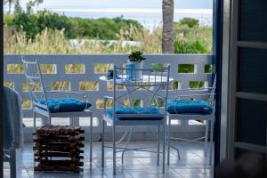 a table and two chairs on a porch with a view of the ocean at Spitaki by the Sea in Paralimni