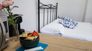 a bedroom with a bed and a table with a vase of flowers at Torino Comfort 10 in Turin