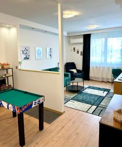 a living room with a ping pong table in it at VestaLak in Tata