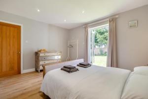 a bedroom with a large white bed and a window at 2 Bed in Oxborough oc-r29290 in Oxborough