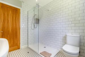 a bathroom with a toilet and a glass shower at 2 Bed in Oxborough oc-r29290 in Oxborough +17 photos