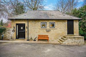 a brick house with a bench in front of it at 2 Bed in Shotley Bridge oc-h29037 in Shotley Bridge