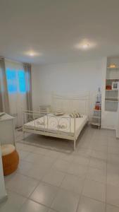 a bedroom with a white bed and a tiled floor at Infinity View Villa Panoramic Aegean Siviri in Siviri +26 photos