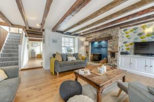 a living room with a couch and a table at 3 Bed in Appledore oc-f29064 in Appledore