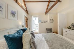 a bedroom with a white bed with blue pillows at 3 Bed in Appledore oc-f29064 in Appledore