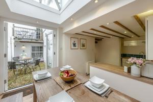 a kitchen and living room with a wooden table and a bowl of fruit at 3 Bed in Appledore oc-f29064 in Appledore