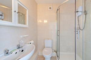 a bathroom with a toilet and a sink and a shower at 3 Bed in Filleigh oc-b28914 in West Buckland
