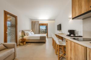 a hotel room with a bed and a kitchen at EMERALD Luxury Living in Syvota