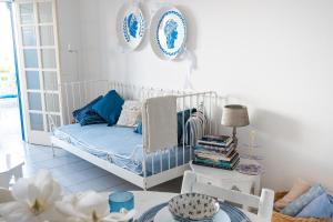 a room with a bed and a table with plates on the wall at Spitaki by the Sea in Paralimni