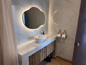 a bathroom with a sink and a mirror at Hotel Paseo del Sol in La Paz +38 photos