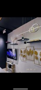 a room with paintings of leaves on the wall at A&R Haven in Manila